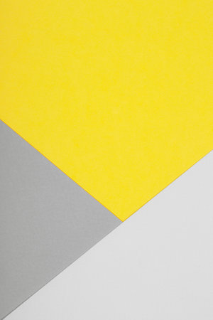 Paper background in two trendy colors - yellow and gray. Demonstrating colors of the yearの写真素材