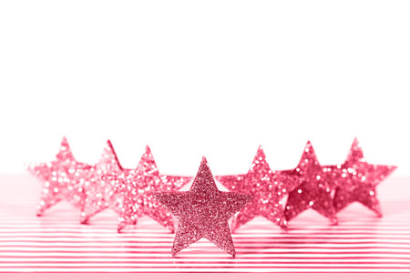 Textured glittering red stars on white background. Demonstration of color of the year.の写真素材