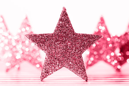 Textured glittering red stars on white background. Demonstrating Viva Magenta - trendy color of the year 2023の写真素材