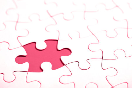 White puzzle with missing part on red background. Business concept. Demonstrating Viva Magenta - trendy color of the year 2023の写真素材