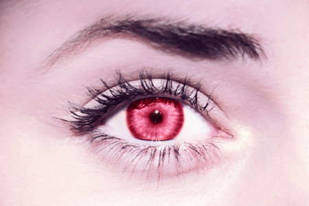 Red womans eye. Demonstrating Viva Magenta - trendy color of the year 2023の写真素材