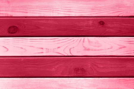 Light red wood plank wall texture background. Demonstrating Viva Magenta - trendy color of the year 2023の写真素材