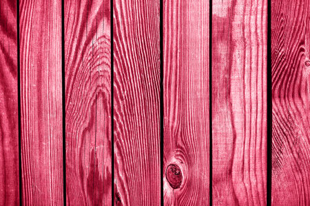 Light red wood plank wall texture background. Demonstrating Viva Magenta - trendy color of the year 2023の写真素材