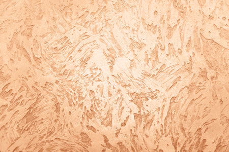 Golden background with the rough texture for your design. Demonstrating color of 2024 year - peach.の写真素材