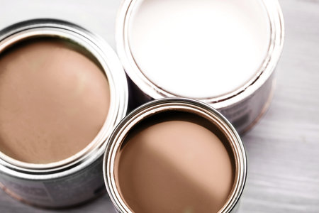 Open paint cans showcasing various shades of brown and white colors.の写真素材