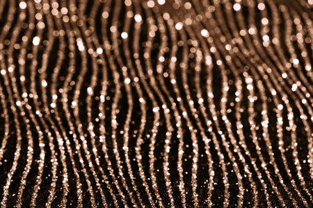 Golden glittering abstract pattern with shimmering lines and sparklesの写真素材