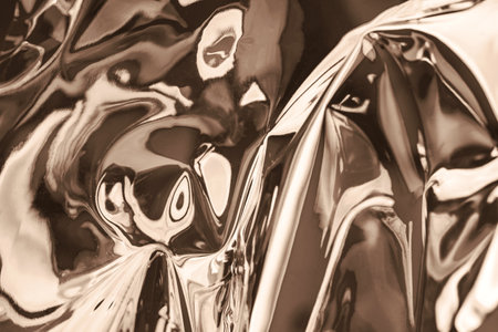 Abstract metallic surface with reflections in soft brown tonesの写真素材