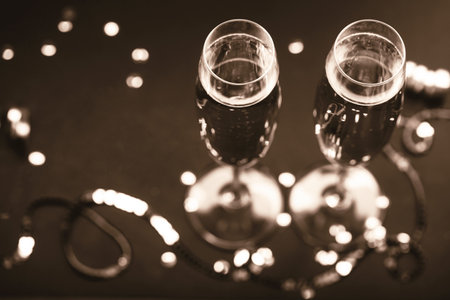 Two champagne glasses with festive decorations on a dark backgroundの写真素材