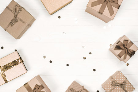 Elegant gift boxes arranged on a wooden surface with shiny decorationsの写真素材
