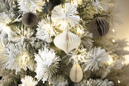 Flocked christmas tree with paper honeycomb ornaments.の写真素材