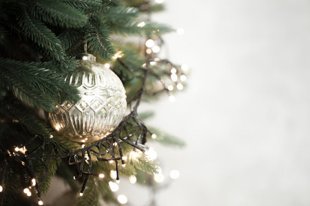 Christmas tree decorating with golden bauble and string lights. Color of 2026 year dancer in the white cloudの写真素材