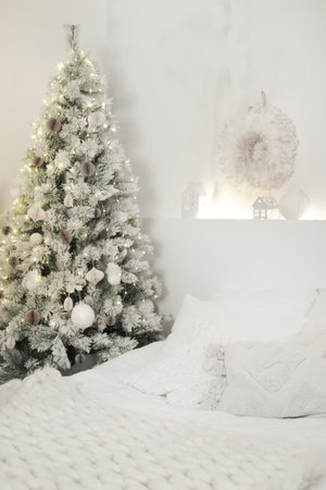 Christmas tree decorating cozy white bedroom interior. Color of 2026 year dancer in the white cloudの写真素材