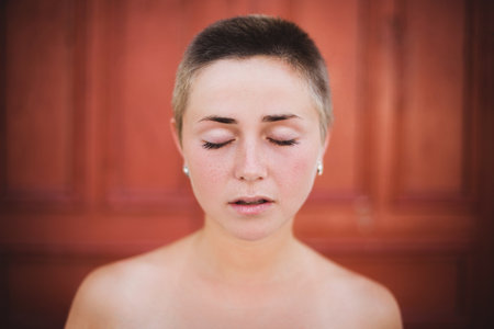 Woman with buzzed hair meditating with closed eyesの写真素材