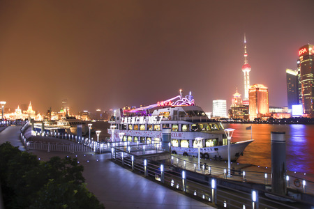 Shanghai, China - Jul 3, 2012   Boat at harbour with passengers have Shanghai skyline at night...