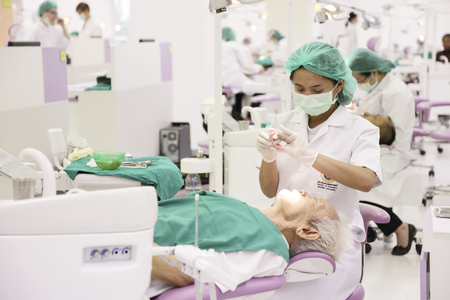 Rama dental hospital, Bangkok, Thailand - Feb 27, 2013   Dentist woking on and old patient in Rama Hospital のeditorial素材