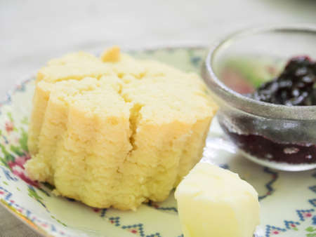 Bangkok, Thailand - Sep 13, 2014 : bear shape scone with butter and raspberry jam on colour plate