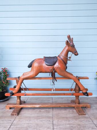 Prachuap Khiri Khan, Thailand - December 11, 2015 : wooden rocking deer with real backgroundの写真素材
