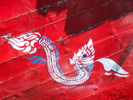 Koh Samae sarn - Pattaya, Thailand - December 30, 2015 : unidentified Naga Thai painting on woodの写真素材