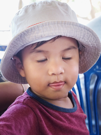 Koh Samae sarn - Pattaya, Thailand - December 30, 2015 : Thai's Cute male wearing hat and close eyeのeditorial素材