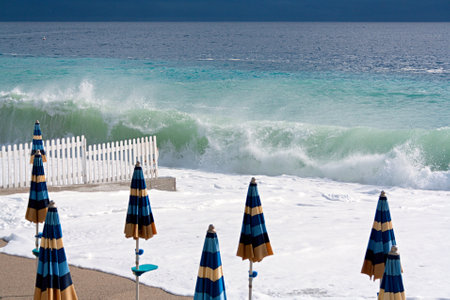 wave on seaside and umbrellas