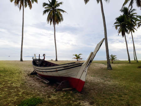 An old fisherman boat by the seaの写真素材