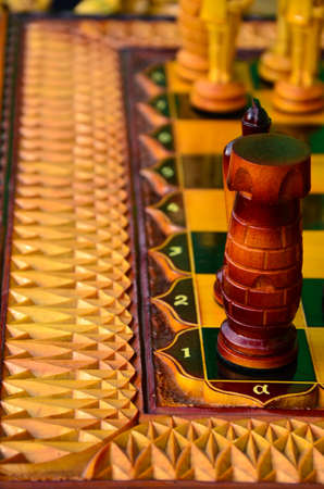 Chess board. wooden figures . carved wooden chess . yellow and brown. high relief and chess. beautiful pieces of handmade chessの写真素材