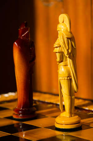 Chess board. wooden figures . carved wooden chess . yellow and brown. high relief and chess. beautiful pieces of handmade chessの写真素材