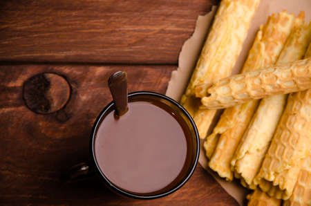 tubular wafer. waffles on wooden boards. hot chocolateの写真素材