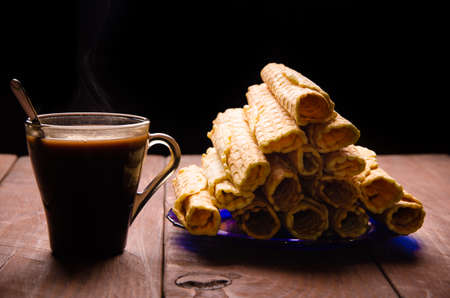 tubular wafer. hot chocolate. waffles on wooden boardsの写真素材