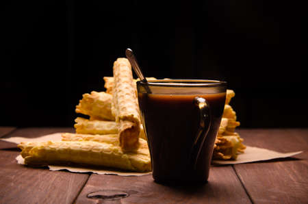 tubular wafer. waffles on wooden boards. hot chocolateの写真素材