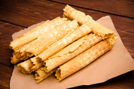 tubular wafer. waffles on Kraft paper. waffles on wooden boardsの写真素材
