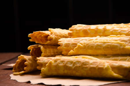 tubular wafer. waffles on Kraft paper. waffles on wooden boardsの写真素材