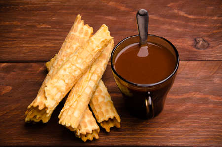 tubular wafer. hot chocolate. waffles on wooden boards