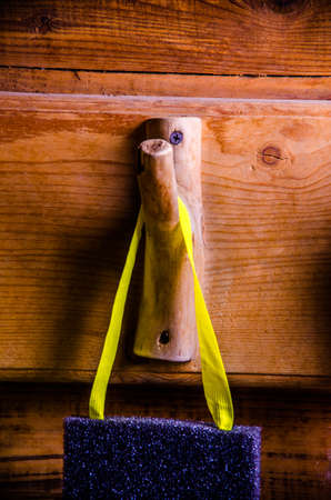 washcloths hanging on wooden hooks. Sponge for washing on a hangerの写真素材