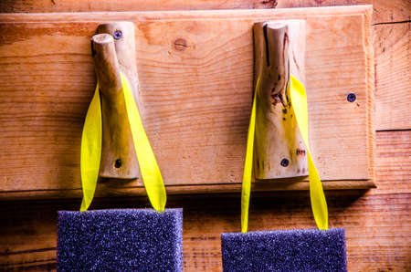 washcloths hanging on wooden hooks. Sponge for washing on a hangerの写真素材