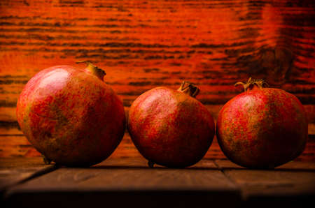 ripe pomegranate on wooden boards. juicy pomegranate on wooden boards.の写真素材