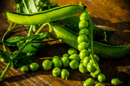 ripe green peas on wooden boards. juicy beansの写真素材