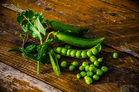 ripe green peas on wooden boards. juicy beansの写真素材