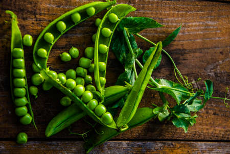 ripe green peas on wooden boards. juicy beansの写真素材