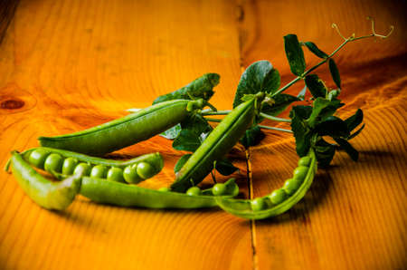 ripe green peas on wooden boards. juicy beansの写真素材