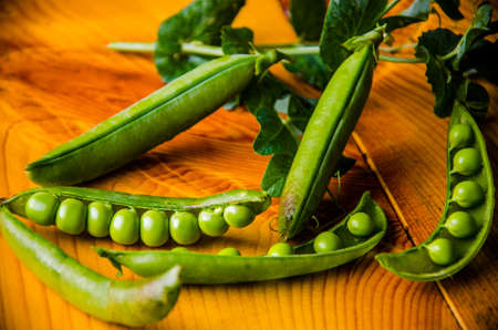 ripe green peas on wooden boards. juicy beansの写真素材