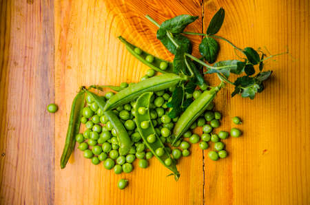 ripe green peas on wooden boards. juicy beansの写真素材