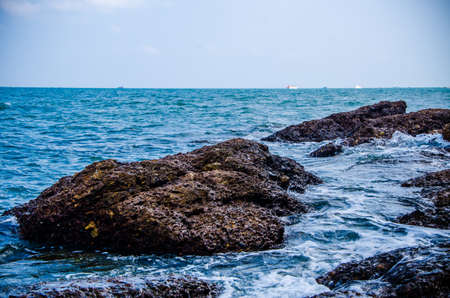 Ocean waves breaking on the rocks on the shore