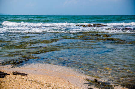 Ocean waves breaking on the rocks on the shoreの写真素材
