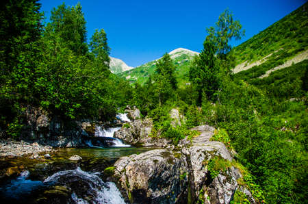 fast mountain waterfall with clear spring water. beautiful view.の写真素材