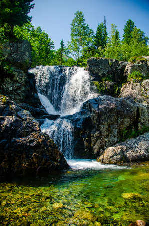 fast mountain waterfall with clear spring water. beautiful view.の写真素材