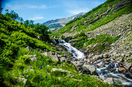 fast mountain waterfall with clear spring water. beautiful view.の写真素材