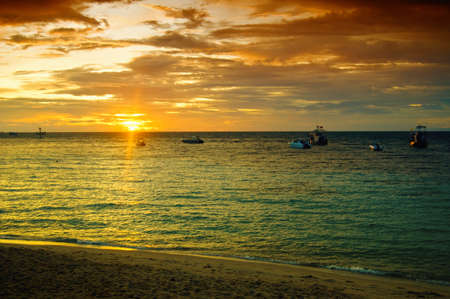Gorgeous tropical sunset on seashore.