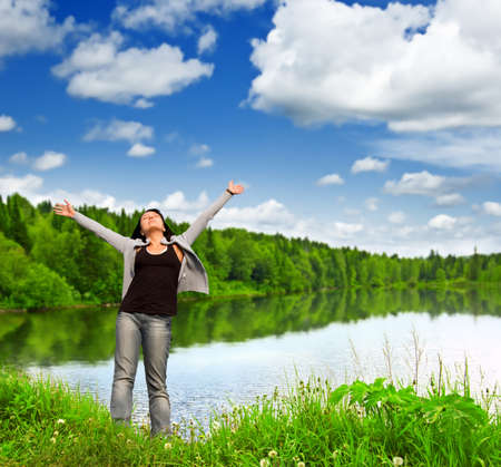 Young woman near the lake.の写真素材
