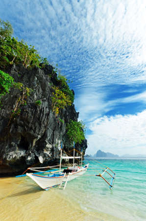 Tropical sea landscape. Boat on the beach.の写真素材